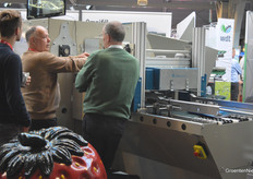 Grower Ronald van Asseldonk (in the middle) inquires about a machine from Demtec.